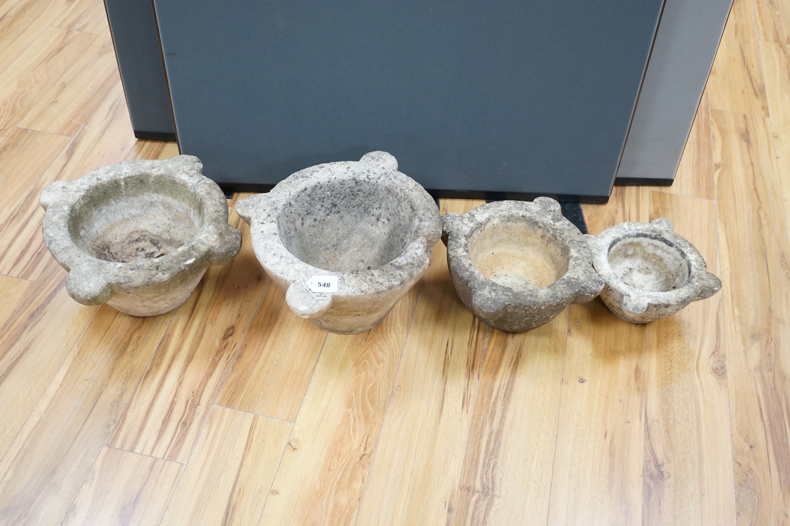 Four graduated marble mortars, largest 46.5cm wide across top rim. Condition - largest mortar has a handle missing, all have been stored outside and are marked